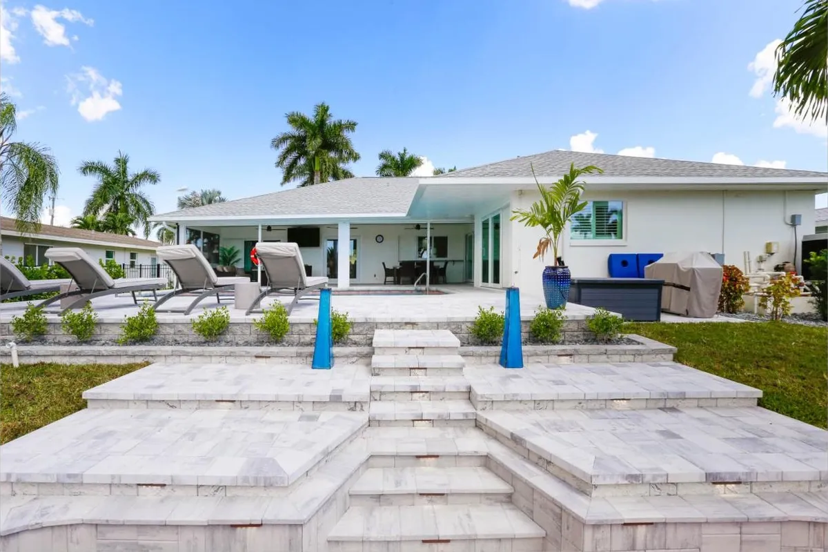 Rear of the home with pool and paver patio